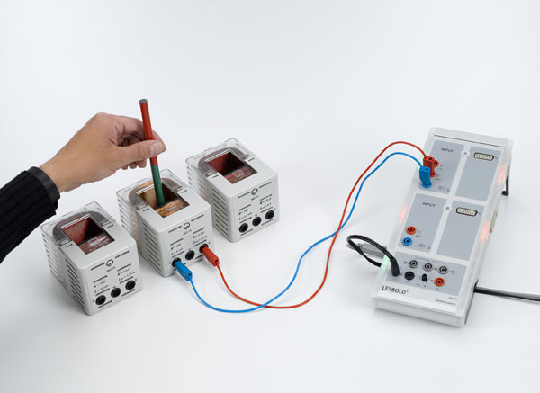 Generating a voltage surge in a conductor loop with a moving permanent magnet